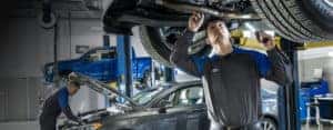 Ford service worker conducting maintenance on vehicle