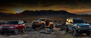 Three Ford 2020 Broncos on desert landscape at sunset