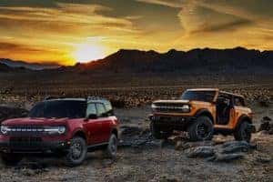 Two Ford 2020 Broncos on desert landscape at sunset