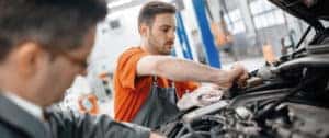 Mechanic working under the hood of a car