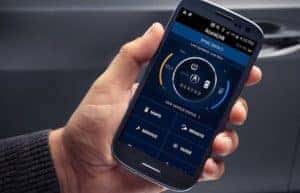 man holding phone with acuralink app