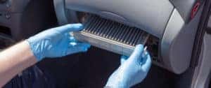 mechanic changing cabin air filter