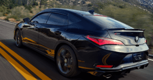 2023 black acura integra whizzing down a scenic road