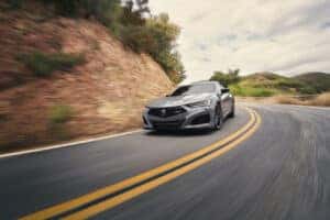 Acura TLX curving around mountain