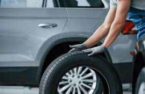 Be,Right,Back ,Mechanic,Holding,A,Tire,At,The,Repair