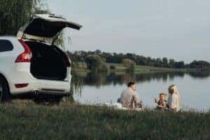 SUV with Family near Lake