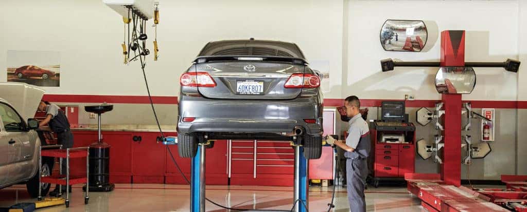 Toyota Service technician removes tire