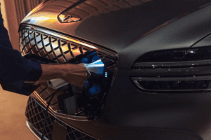 2025 Genesis Electrified GV70 plugged into a charging station, showcasing its fast-charging capability.