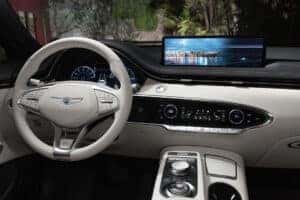 2025 Genesis Electrified GV70 infotainment system with dual 12.3-inch displays showcasing navigation and entertainment features