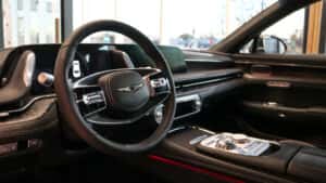 2025 Genesis G90 luxury sedan in motion, showcasing powerful performance and smooth handling