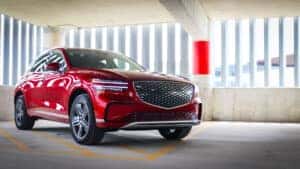 The 2026 Genesis Electrified GV70 in motion, highlighting its powerful acceleration, sleek design, and dynamic handling on a winding road.