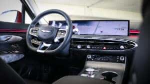 2026 Genesis Electrified GV70 dashboard displaying Blind-Spot View Monitor and driver-assist features, emphasizing advanced safety technology and driver awareness systems.
