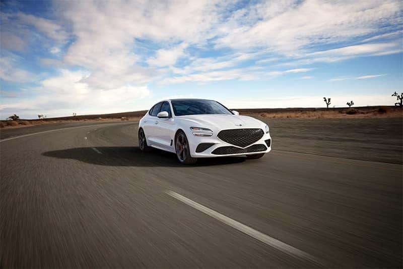 Close-up of the 2026 Genesis G70 front headlamps, showcasing sleek LED design and sharp detailing.