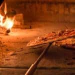Brick oven with flames and ember ready to cook a delicious pizza