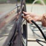 close up of man filling up tires