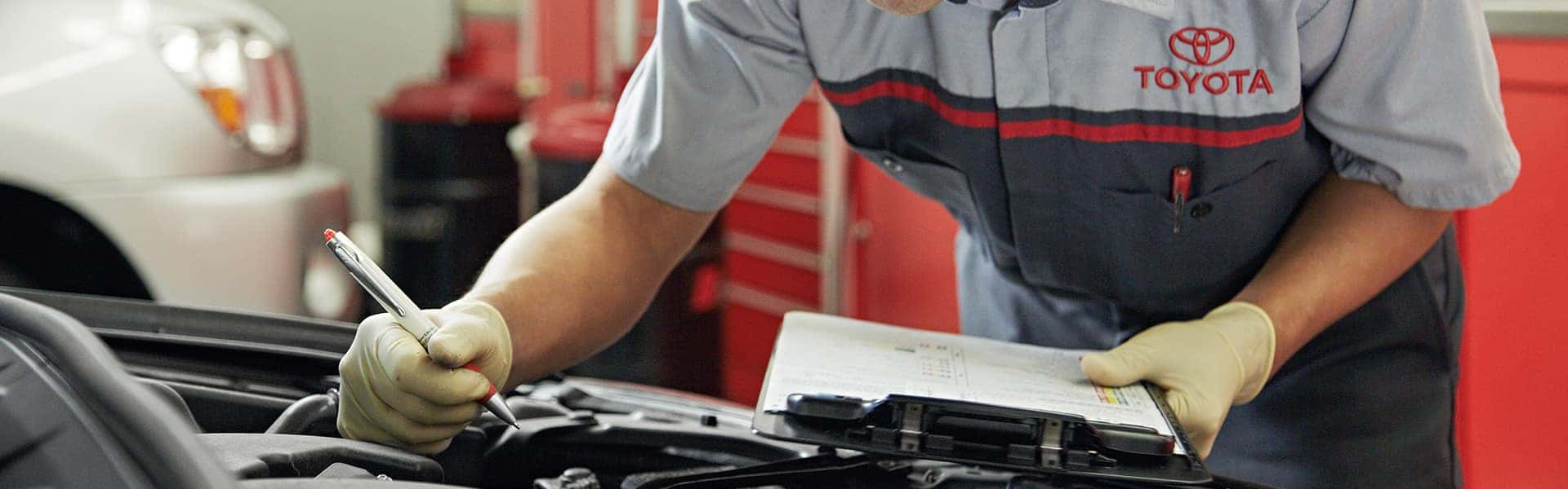 Lancaster Toyota is a Car Dealership in Lancaster near Brownstown, PA | Toyota Service Advisor Preforming Multi-Point Inspection on Toyota Vehicle