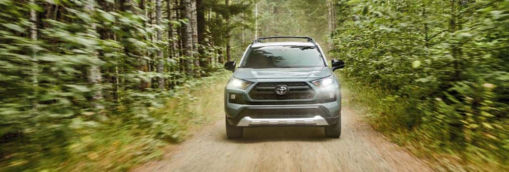 Compare the 2021 Toyota RAV4 vs. the 2021 Nissan Rogue at Lancaster Toyota | RAV4 racing through woods