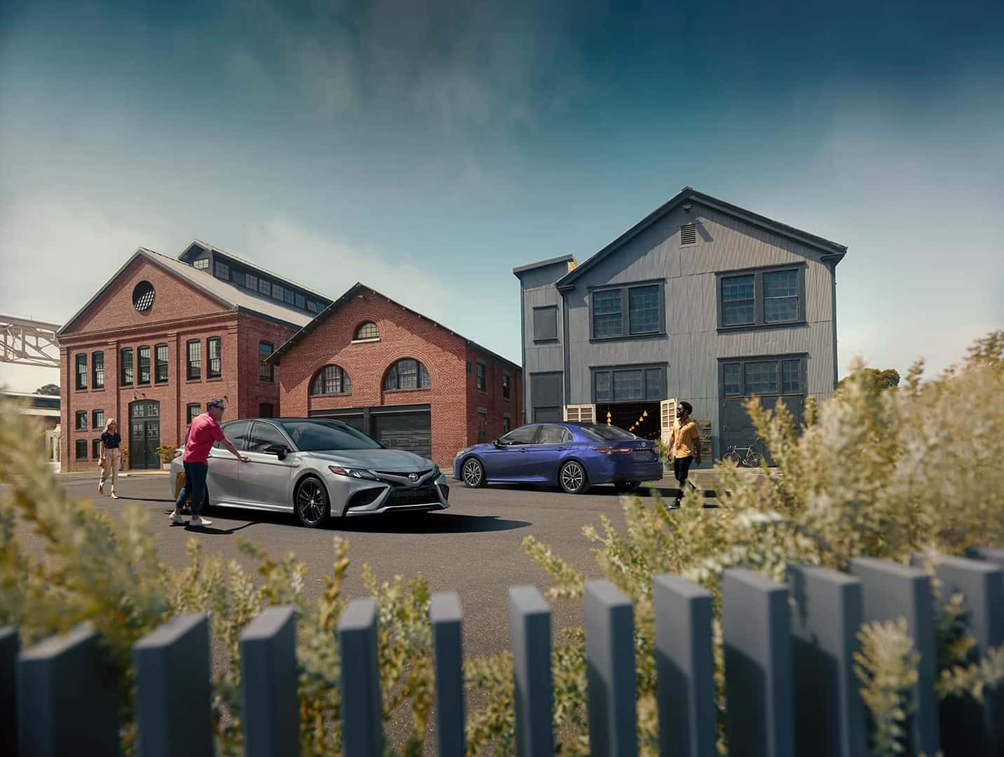 Model Features of the 2022 Toyota Camry at Lancaster Toyota | Two 2022 Toyota Camrys parked in a neighborhood