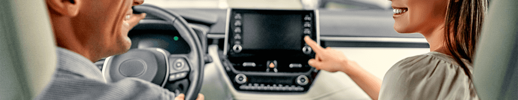 Enjoy A Test Drive At Lancaster Toyota in East Petersburg, PA | Man sitting on the drivers side is talking to a woman in the passenger side about the car interior