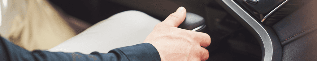 Enjoy A Test Drive At Lancaster Toyota in East Petersburg, PA | A person's hand on a black shift knob of a car