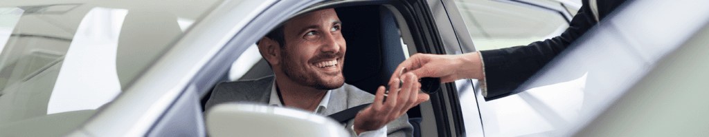 Enjoy A Test Drive At Lancaster Toyota in East Petersburg, PA | New car keys being handed to a man smiling in silver car