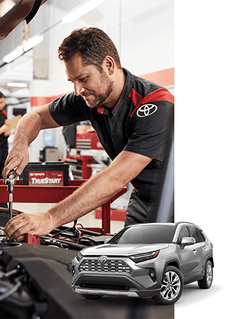 ToyotaCareAt Lancaster Toyota in East Petersburg, PA | Front view of a grey Toyota RAV4 with a background of a Mechanic wearing Toyota uniform while working in the engine bay