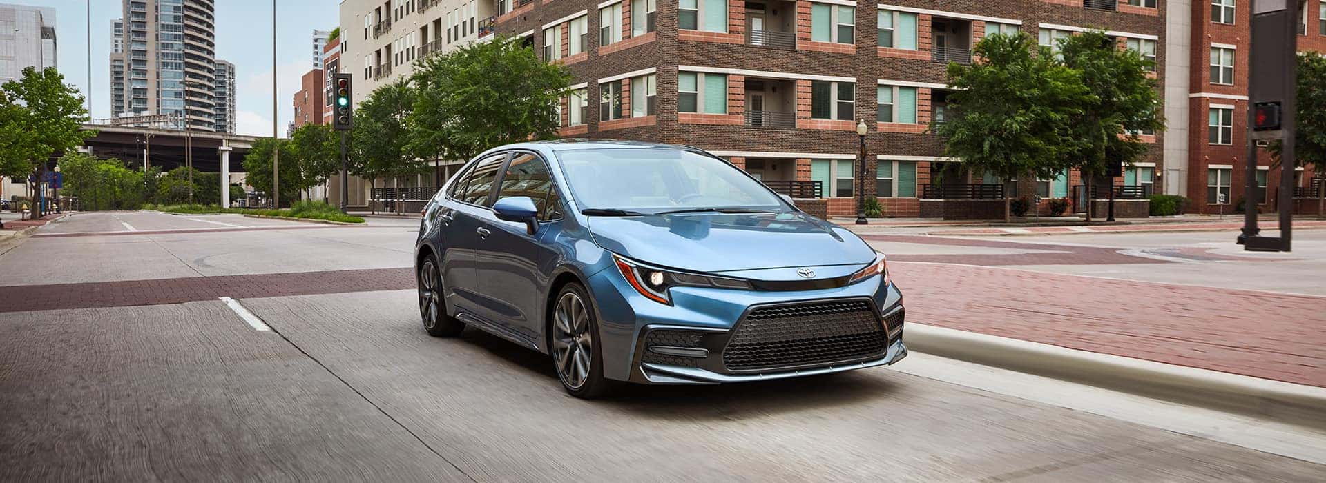Blue 2024 Toyota Corolla Driving Through City Intersection | Basic Car Maintenance and Servicing Checklist | Lancaster Toyota
