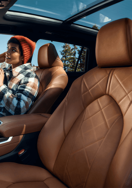 Accessories that help keep your Toyota protected at Lancaster Toyota in East Petersburg, PA | Brown leather seats of a Toyota Highlander with a woman sitting in the passenger seat