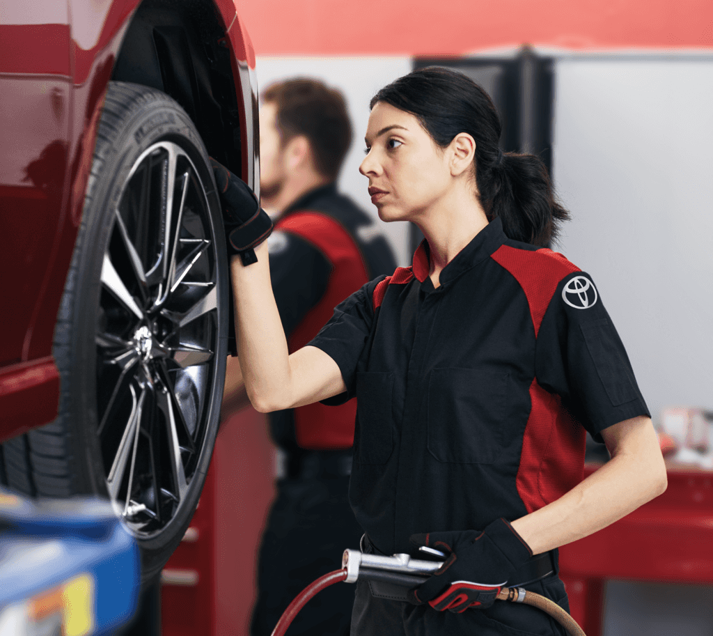 How to check your tires' health at Lancaster Toyota | Toyota mechanic checking the tire tread depth while holding tire pressure tool