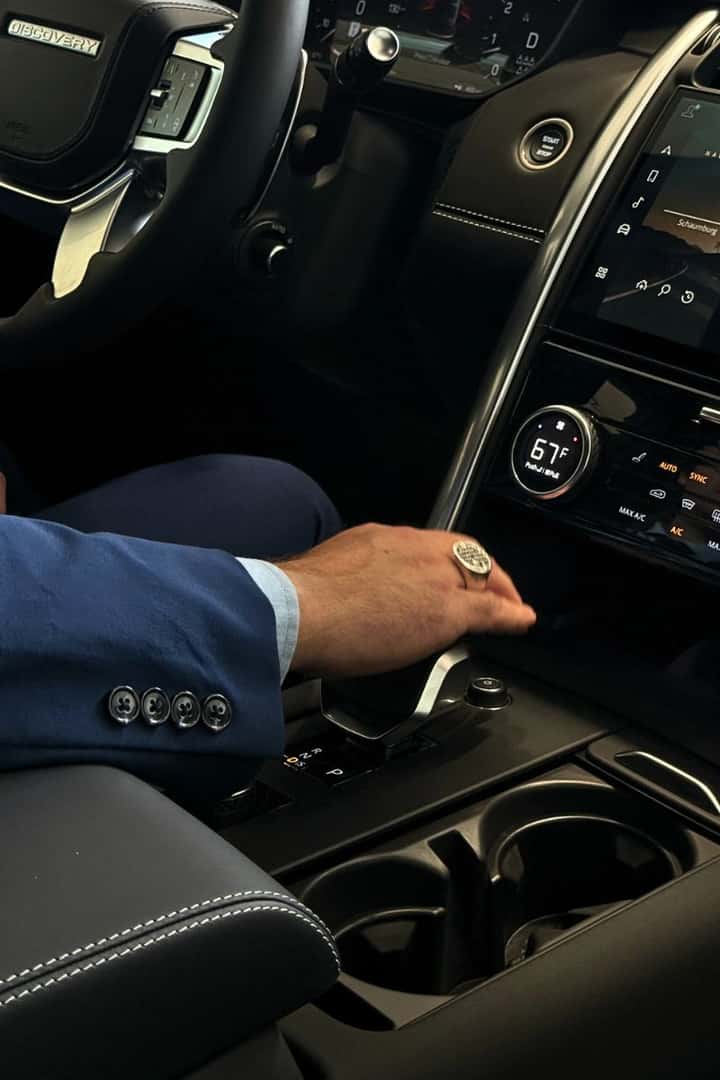 Man shifting 2026 Discovery Tempest into drive. 