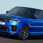 bright blue 2019 range rover sport driving on open highway