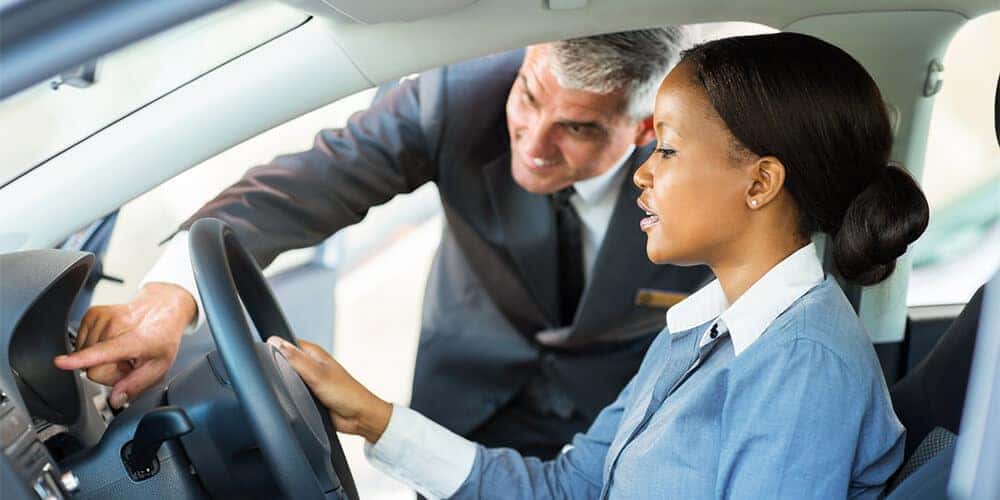 Woman looking at new car