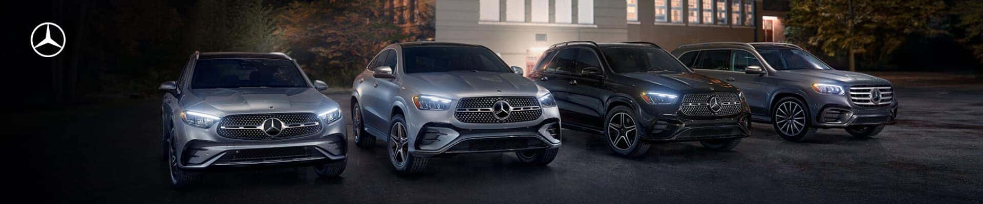 Four Mercedes-Benz SUVs: GLC Coupe, GLE Coupe, GLE, and GLS, parked together at dusk.