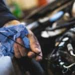 Mechanic checking car oil