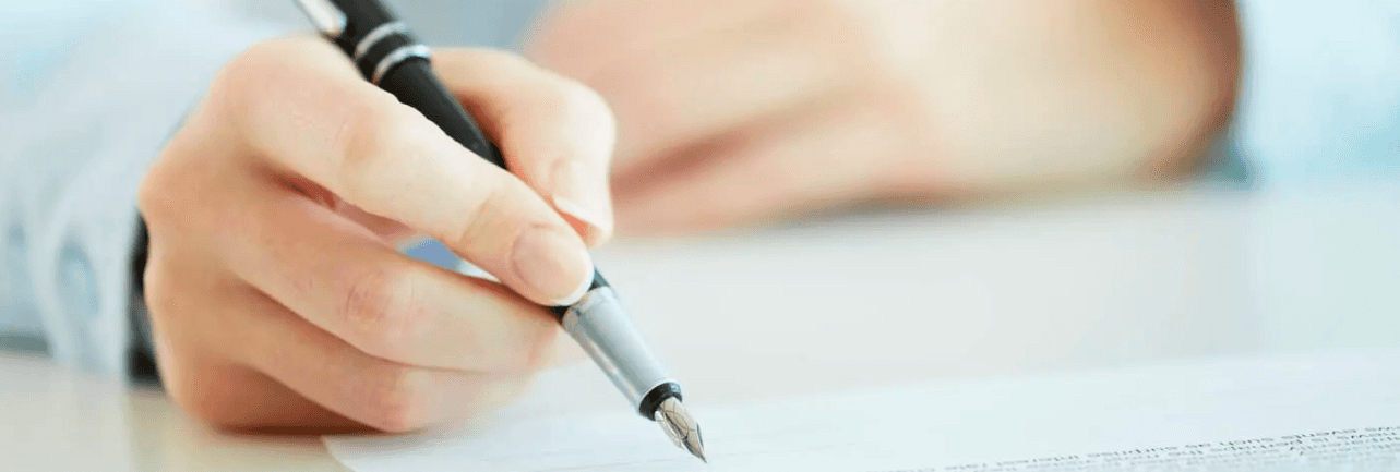 person signing a document