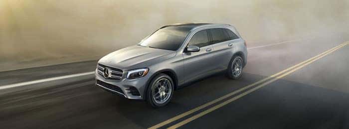 Image of a gray Mercedes-Benz GLC driving on a highway through fog.