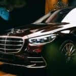 Black Mercedes-Benz parked in a car dealership showroom