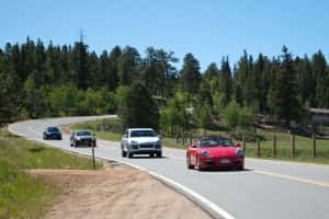A line of beuatiful cars on a winding road - Prestige Imports Mountain Tour 2012