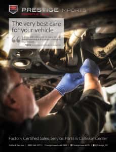 Audi Technician working on a vehicle as it sits on a lift in the Prestige Audi Service Center