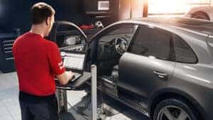 Certified Porsche Technician using specialized diagnostic equipment Certified Porsche Technician using specialized diagnostic equipment