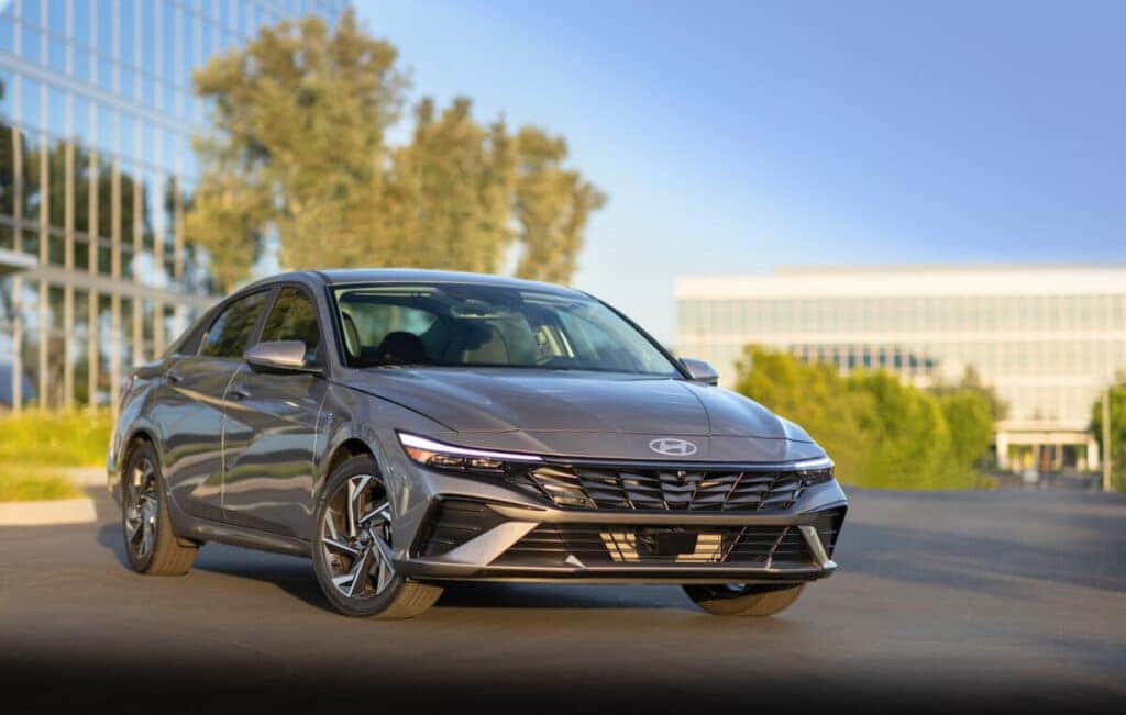 a sleek new 2025 Hyundai Elantra parked in front of glass building