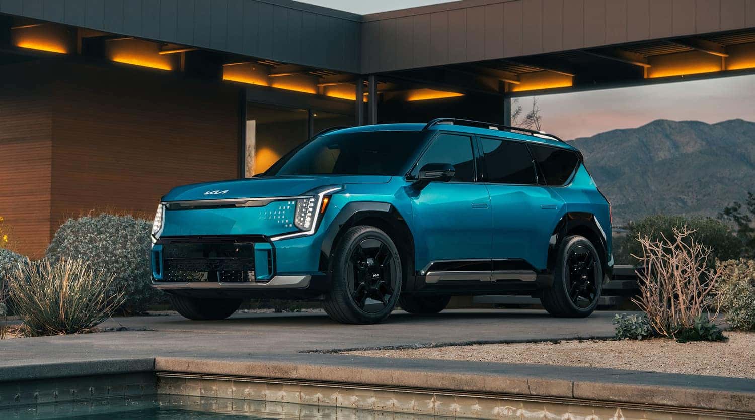 2024 KIA EV9 parked under modern architecture