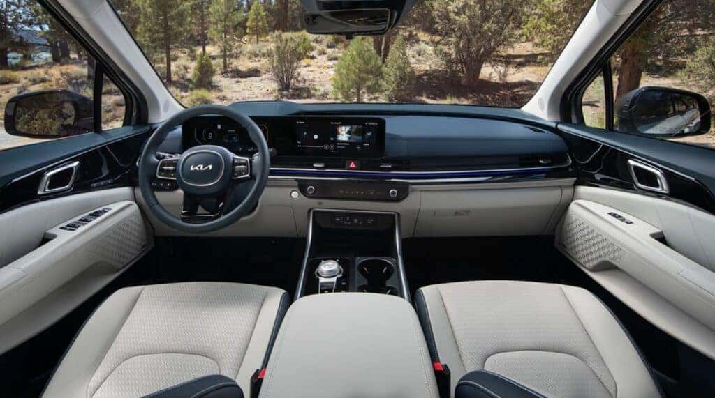The interior of a 2025 Kia Carnival showcasing modern design, spacious seating, and advanced technology features.