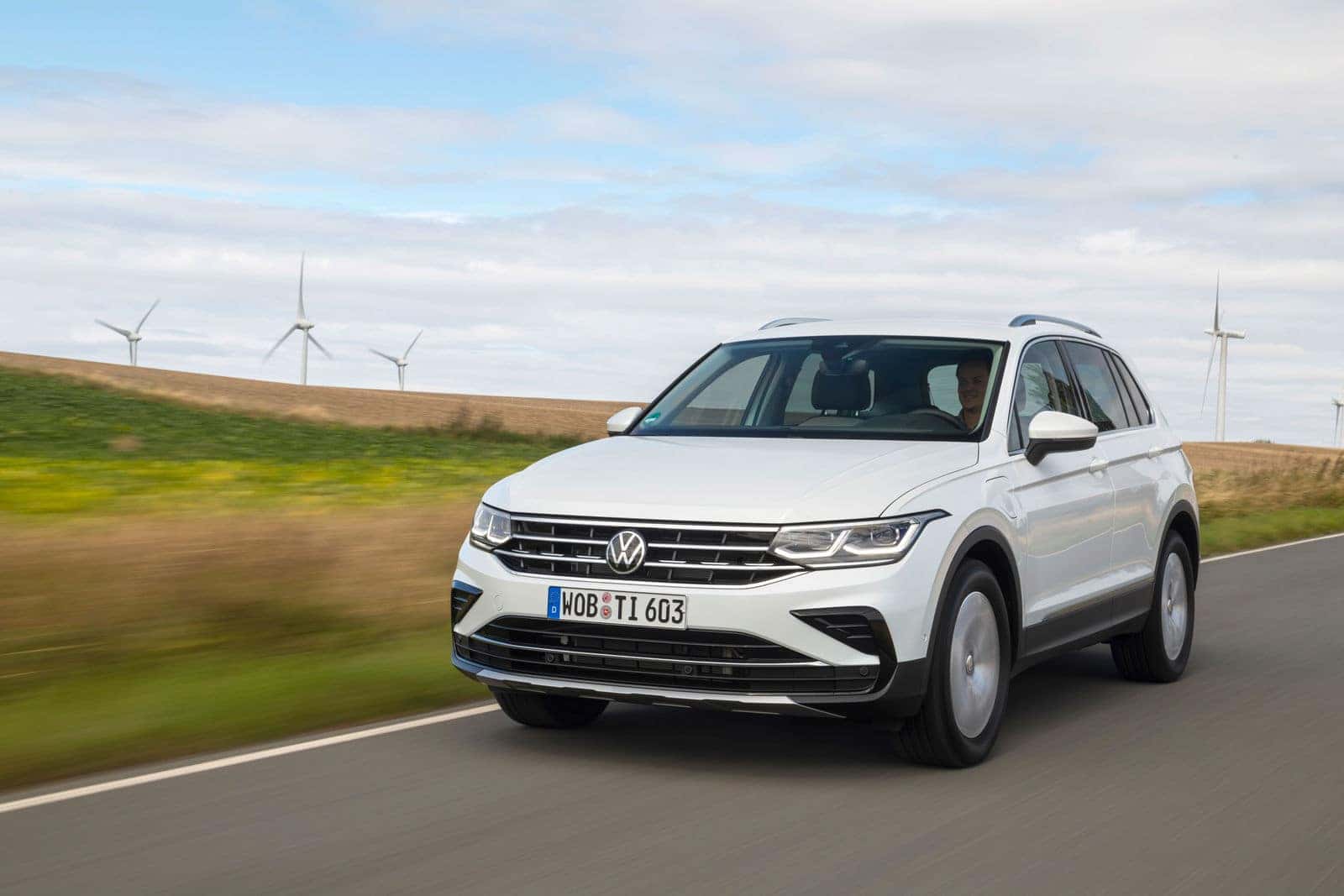 White Volkswagen tiguan SUV windmills