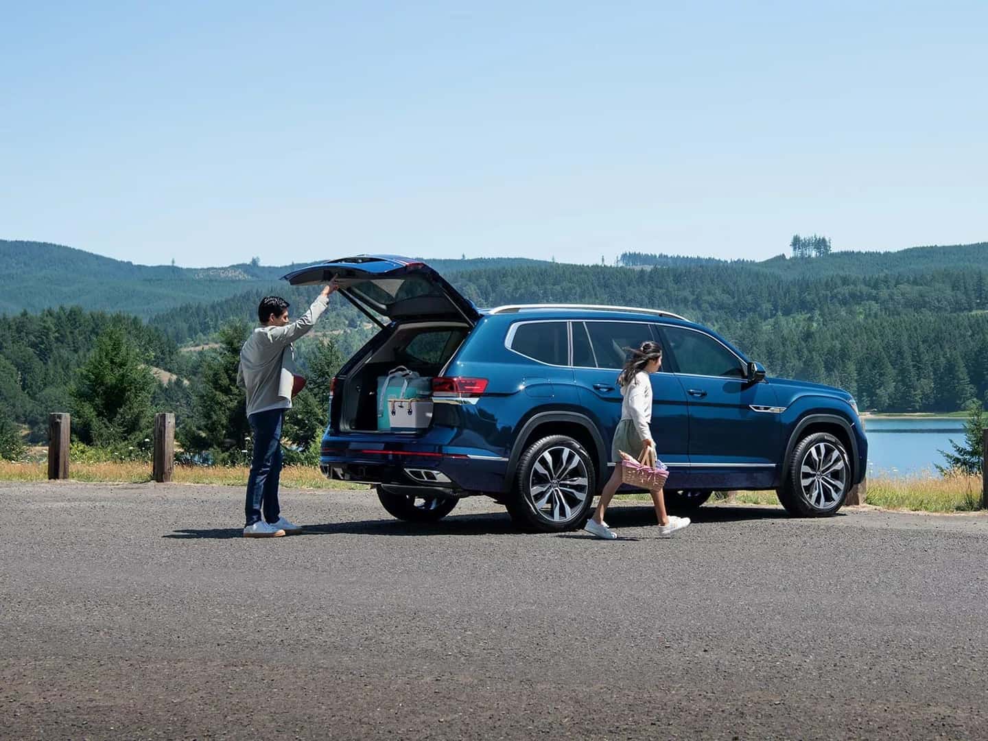 Blue Volkswagen Atlas SUV two People Outside Mountains
