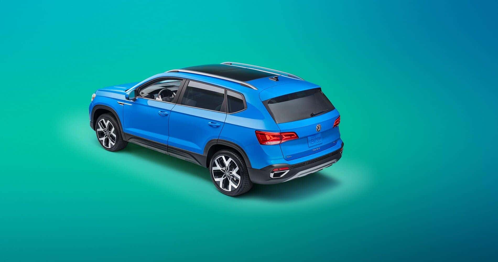 Blue Volkswagen Taos SUV Teal Backdrop