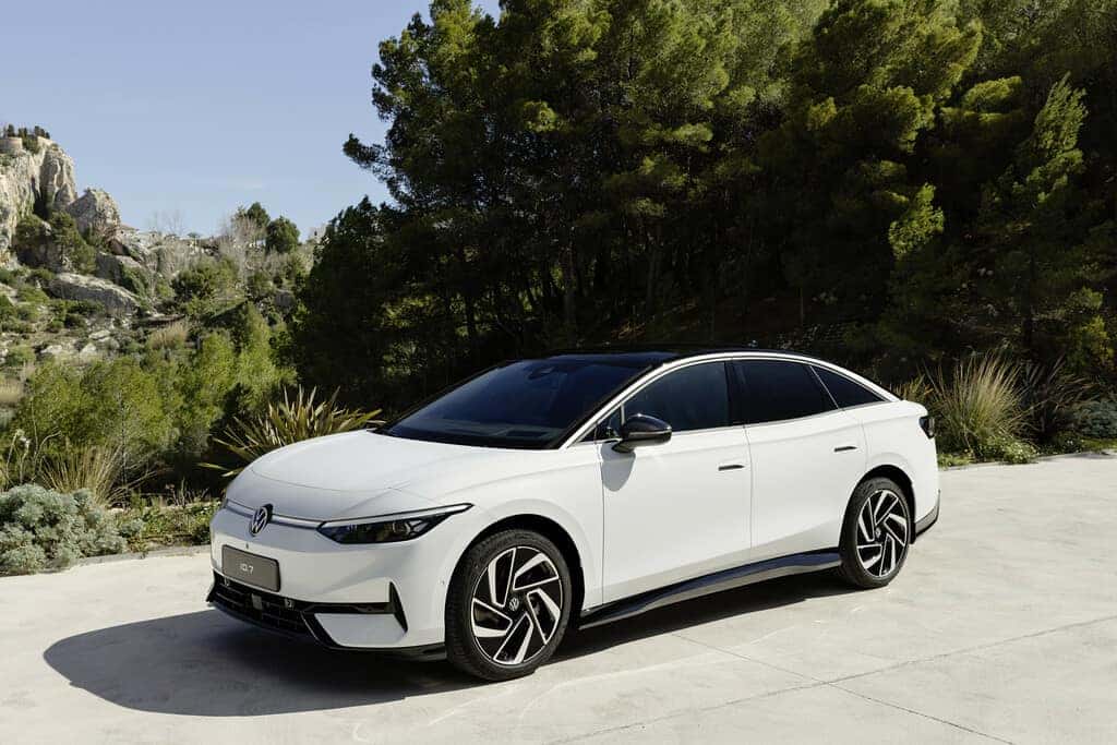 White Volkswagen ID.7 Sedan Bushes Trees