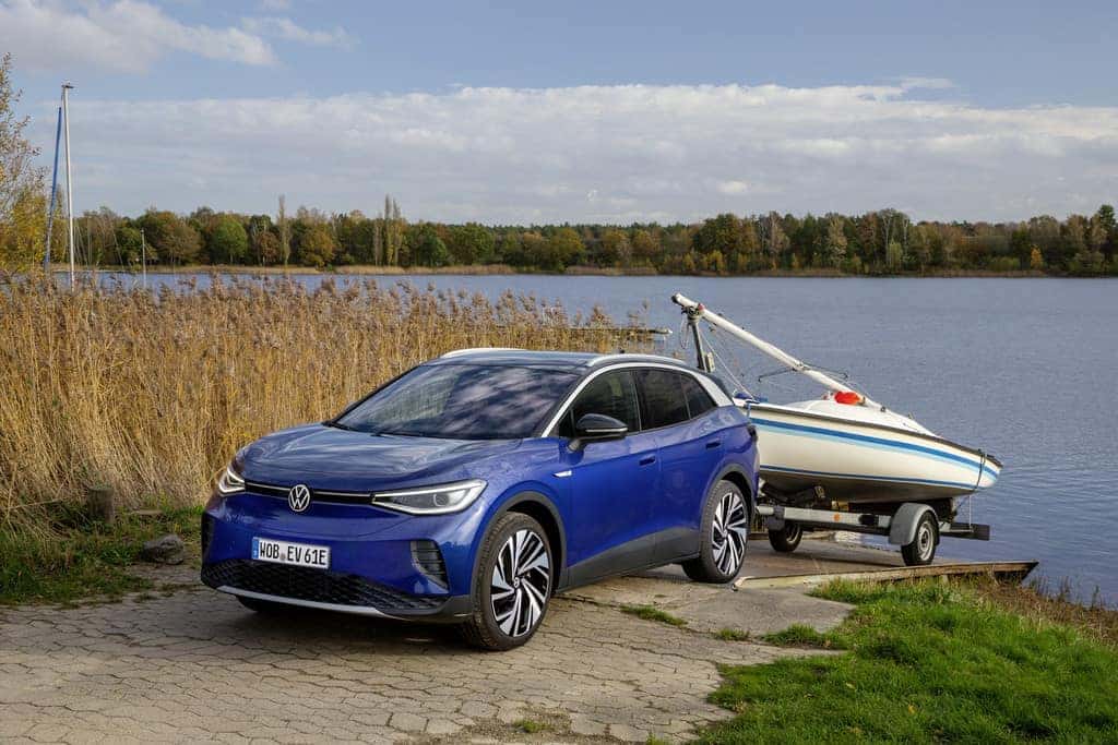 Blue Volkswagen ID.4 EV SUV White Boat Water Blue Sky
