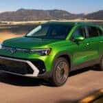 Green 2026 Volkswagen Taos on a mountain road