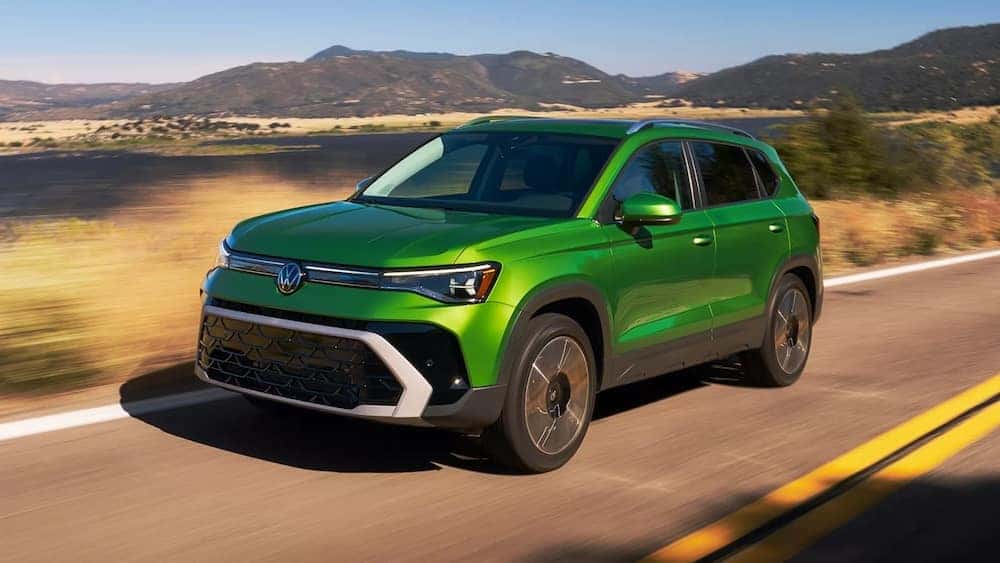 Green 2026 Volkswagen Taos on a mountain road